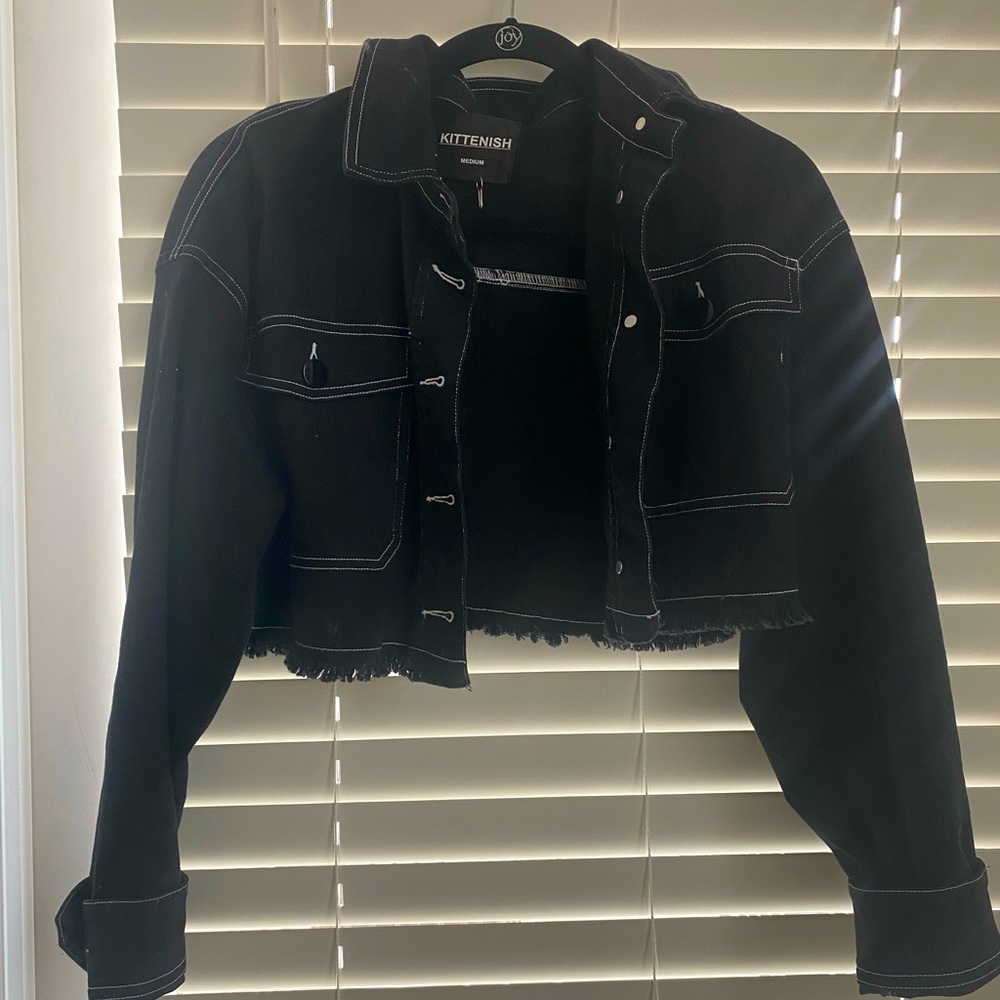 Kittenish brand cropped black denim jacket.